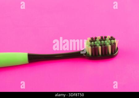 new modern toothbrush isolated on pink solid background Stock Photo