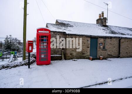Red phone box and post box in the snow Stock Photo