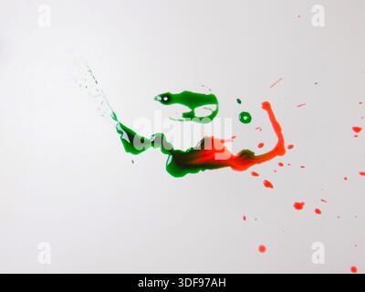 Intricate Splatter And Looping Strokes Of Green And Red Paint On White Plane, Circular Gestures And Drips Form Stock Photo