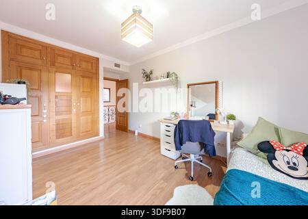 an image of a childrens bedroom with fitted wardrobe and desk in real estate property Stock Photo