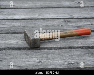 Sledgehammer on the boards old bridge close to Stock Photo