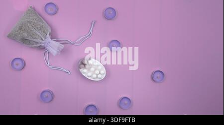 Spa still life with lavender sachet candles and soap on pink background Stock Photo