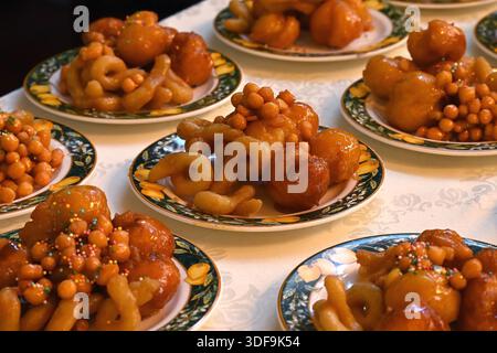 Struffoli Neapolitan fried honey balls on green gold rimmed plates for New Year celebration in Sorrento, Italy Stock Photo