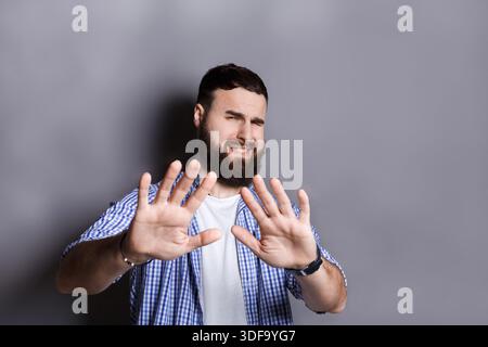Bearded man expressing disgust, grimacing Stock Photo