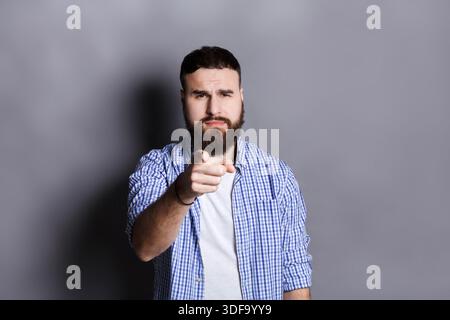 Strict man point gesturing index finger on you Stock Photo