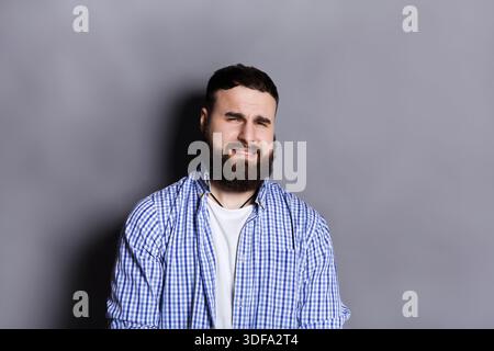 Bearded man expressing disgust, grimacing Stock Photo