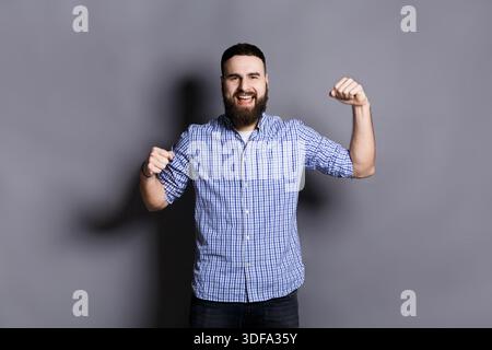Excited bearded man very glad to success Stock Photo
