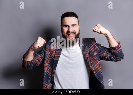 Excited bearded man very glad to success Stock Photo