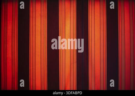 Abstract striped background. Red-orange-black. Art lens. Swirl bokeh. Focus on the center Stock Photo