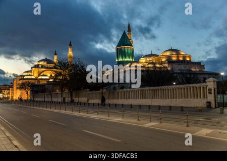 The Mevlana Museum (Turkish: Mevlânâ Müzesi) in Konya-Karatay, Turkey, is illuminated at dusk by its minarets and domes. The museum is the mausoleum of the Sufi mystic Rumi (Jalāl ad-Dīn ar-Rūmī, 1207–1273), with an adjoining mosque; the turquoise dome above his tomb, dating from 1274, is regarded as a landmark of Konya. Stock Photo