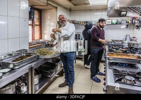 Chef Harun Rasit Dönmez prepares small dried okra pods in his kitchen at Restaurant Lokmahane in Konya, Turkey. Stock Photo