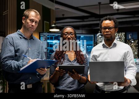 Portrait of teamworking engineers writing code, developing machine learning APIs. Team of IT professionals troubleshooting software errors using artificial intelligence, resolving system crashes Stock Photo