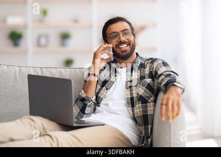 Joyful middle-eastern man freelancer working from home Stock Photo
