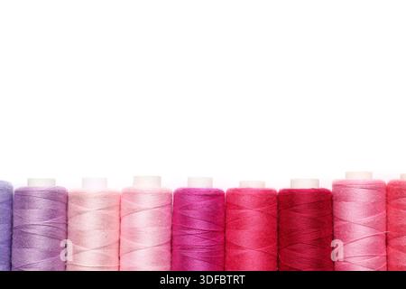 Different spools of thread on white background Stock Photo