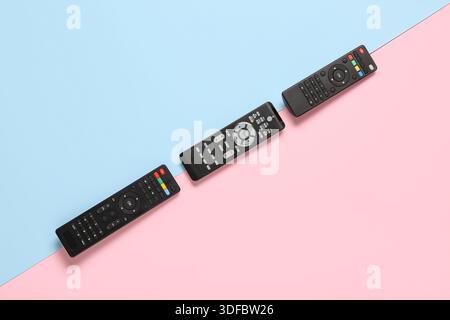 Different modern TV remote controls on color background Stock Photo