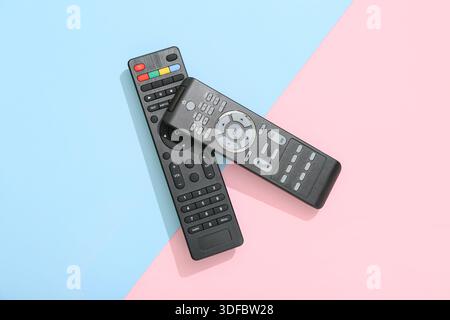 Different modern TV remote controls on color background Stock Photo