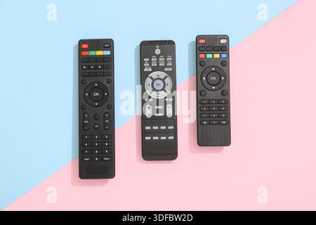 Different modern TV remote controls on color background Stock Photo
