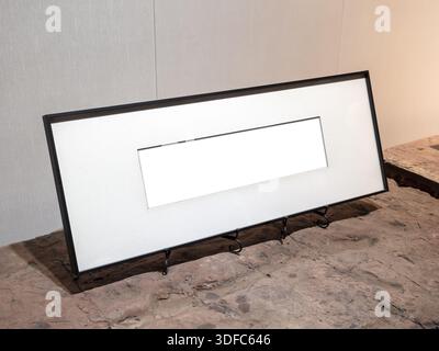 Minimal panoramic photo frame mockup on rustic stone surface. Ideal for showcasing horizontal artworks, typography, or landscape photography in a clea Stock Photo
