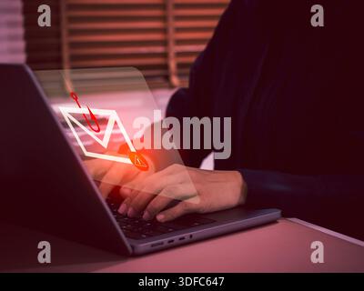 Phishing email alert icon on laptop computer screen. Concept of cyber fraud, scam, data theft, and phishing attacks. Perfect for illustrating digital Stock Photo