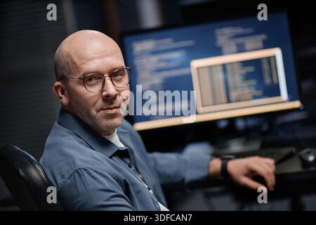 Portrait of Middle Aged Caucasian Man Working with Computer Monitors in Office Stock Photo