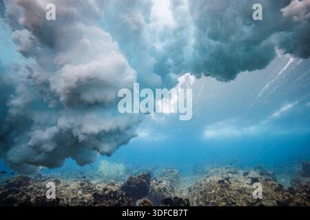 A unique underwater perspective captures a powerful ocean wave as it breaks overhead above a shallow coral reef off the island of Yap in Micronesia. S Stock Photo