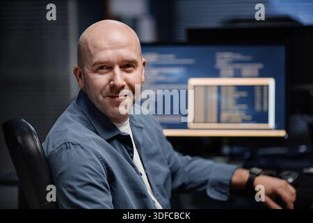 Portrait of Middle Aged Caucasian Man Smiling While Working on Computer Stock Photo