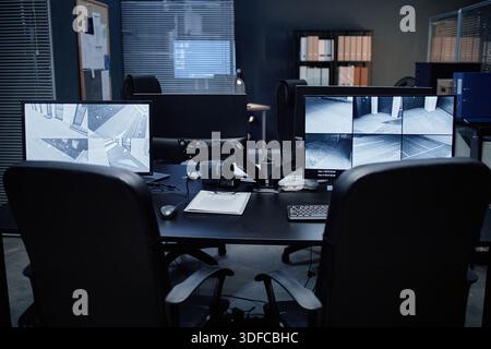 Empty Security Office Showing Surveillance Monitors Displaying Building Footage Stock Photo