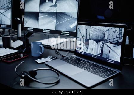 Multiple Surveillance Camera Feeds Displaying on Computer Monitors in Office Stock Photo