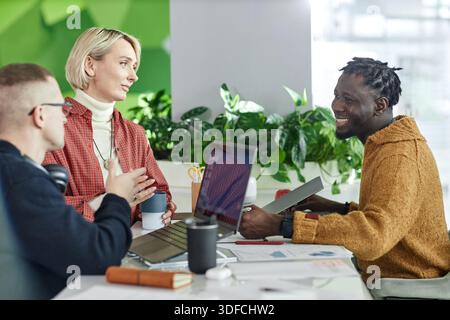Young Multiethnic Colleagues Collaborating during Informal Office Meeting Stock Photo