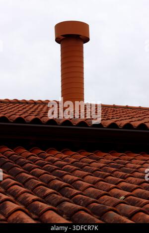 Roof with tiles and a chimney Stock Photo