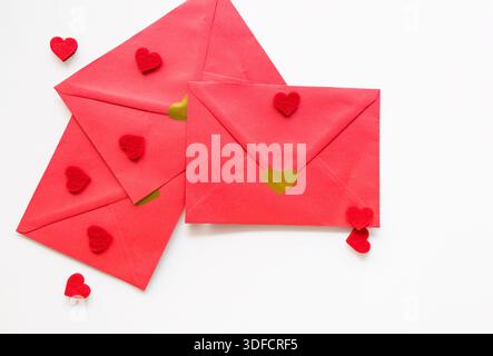 Red envelopes decorated with heart shapes on white background. Ideal for Valentines Day Stock Photo