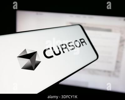 In this photo illustration, a smartphone with the logo of ai software company Cursor (Anysphere Inc.) is seen on screen in front of website. (Photo by Timon Schneider / SOPA Images/Sipa USA) *** Strictly for editorial news purposes only *** Stock Photo
