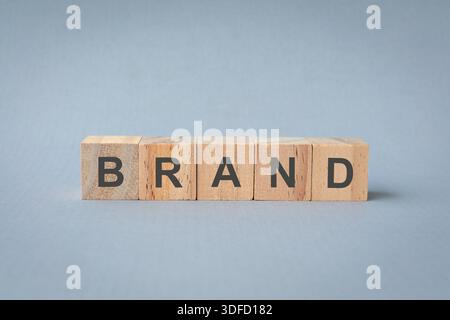 The word Brand on square wooden blocks. Brand building for success concept. Stock Photo