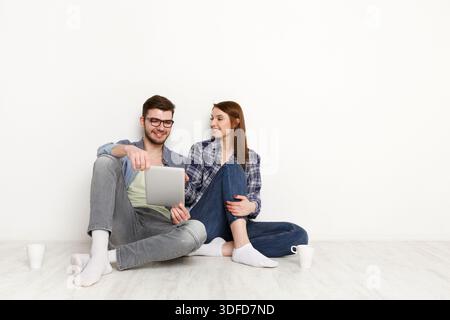 Team work at home with pleasure, couple with digital tablet Stock Photo