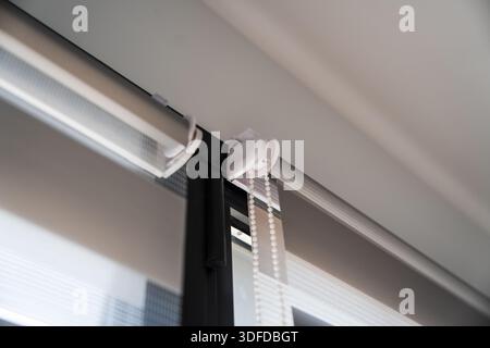 Contemporary window installation with zebra roller blinds showing roller system, fabric layers, and light diffusion Stock Photo