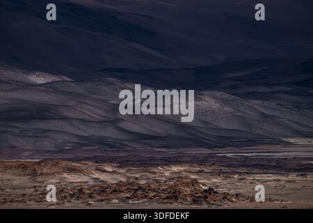 High-resolution shot of dark volcanic sand dunes. Moody, minimalist landscape with soft light and layered textures, ideal for background or editorial Stock Photo