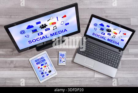 Social media concept shown on different information technology devices Stock Photo