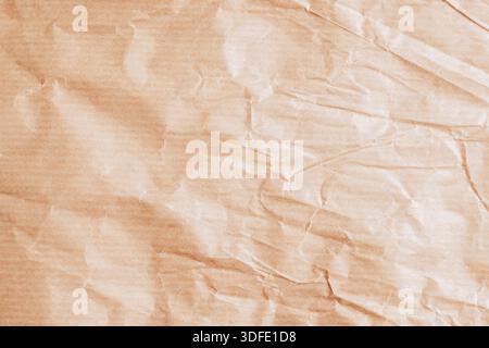 Wrinkled beige paper texture background with creases. Stock Photo