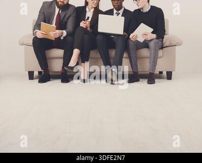 Unrecognizable business people teamwork crop. Team on couch, partners working together Stock Photo