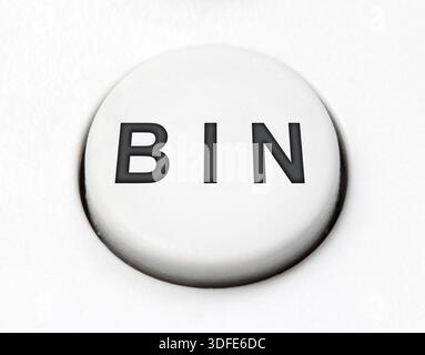 A white round button switch - bin, close up. Control mechanical key for delete on control device Stock Photo