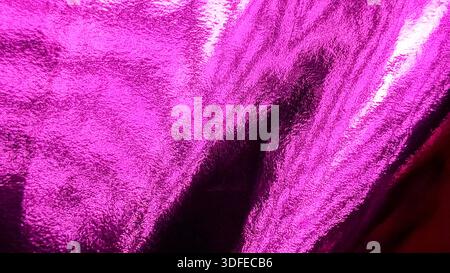 Luxury pink magenta foil background with soft folds and dramatic light reflecting on metallic wrinkled surface Stock Photo