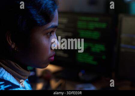 Young South Asian Woman Concentrating While Working on Computer Screen Stock Photo