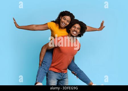 Pretty african american woman riding her lover back Stock Photo