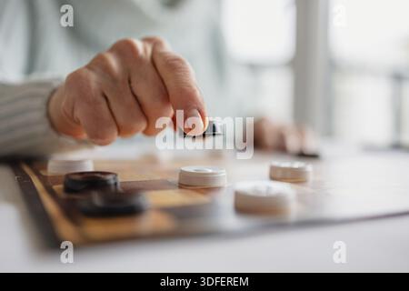 Senior Woman Playing Checkers, close-up Stock Photo