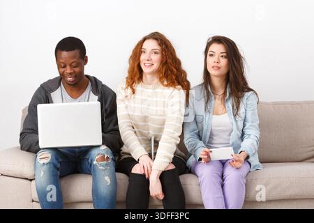 Young people using gadgets, students, technology Stock Photo