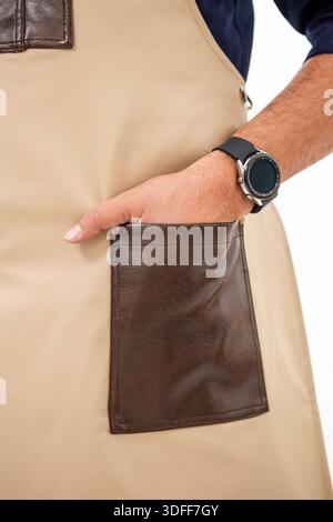 Close-up of beige apron pocket with mans hand and smartwatch. Stock Photo