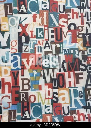 Colorful cotton fabric with overlapping random alphabet letters in vibrant mixed colors, close-up texture background. Photo by Willy Matheisl Stock Photo