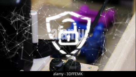 Displaying glowing shield with padlock overlay on workbench, showing network mesh and knobs Stock Photo