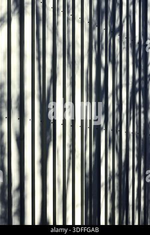 Abstract pattern and shadows on aluminium metal building exterior wall - central France. Stock Photo