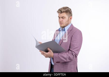Businessman in purple jacket reading documents Stock Photo